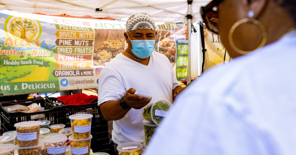 A produce vendor at the Crenshaw Farmers Market photographed for LAist