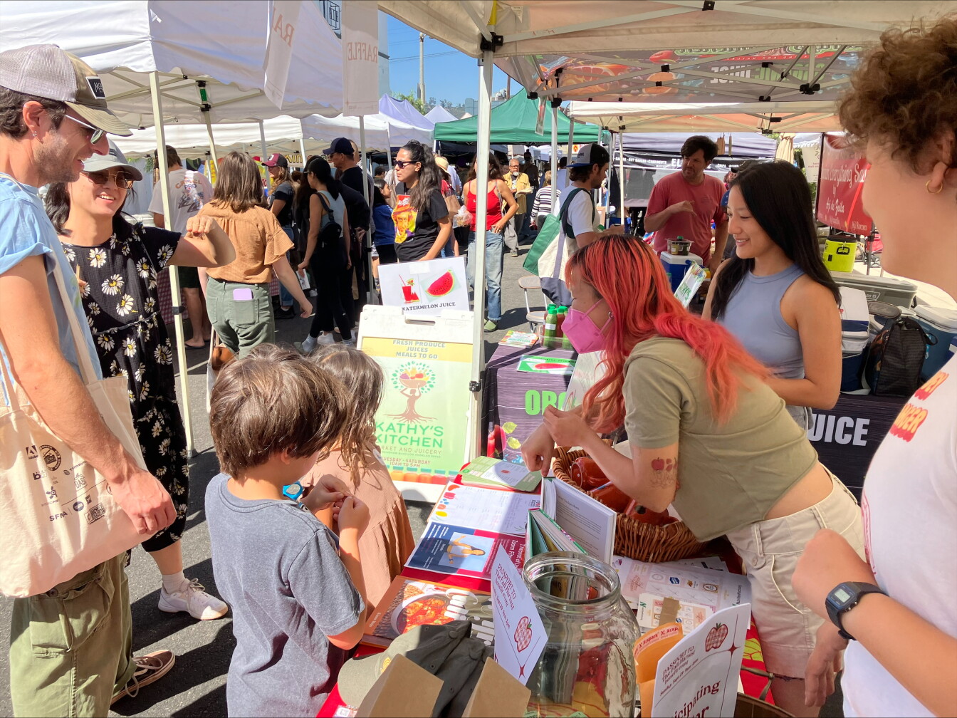 Families visiting a farmers market operated by Food Access LA, the second photograph in Robert Garrova's LAist story