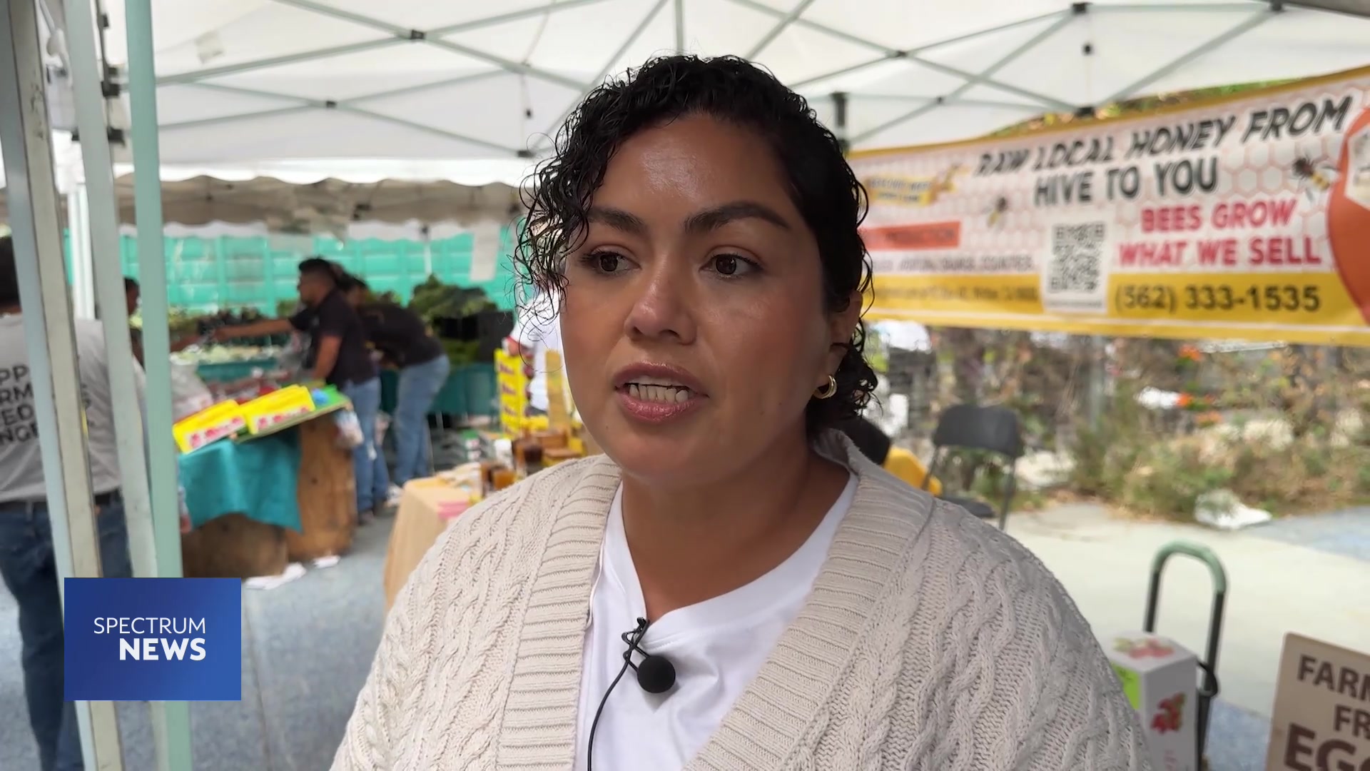 Ceci Campos speaking on camera in Nathalie Basha's Spectrum News report from the Central Avenue Farmers Market